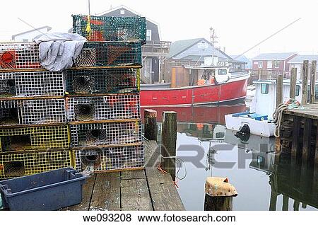 Wire lobster traps on dock and boats in fog at Fishermans Cove Eastern Passage Halifax Nova Scotia View Large Photo Image Stock Photo - Wire lobster traps on dock and boats in fog at Fishermans Cove Eastern Passage Halifax Nova Scotia. Fotosearch