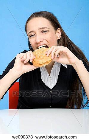 Woman Eating Sandwich and Working View Large Photo Image Stock Image - Woman Eating Sandwich and Working. Fotosearch