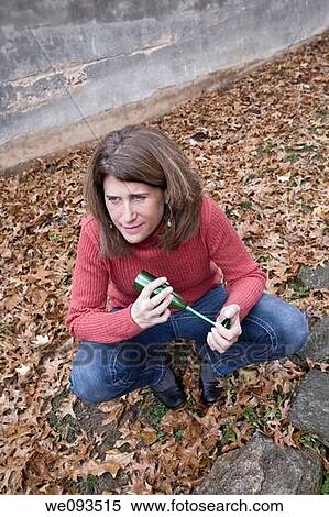 Woman, holding a champagne glass, sitting on fallen leaves View Large Photo Image Stock Photography - Woman, holding a champagne glass, sitting on fallen leaves. Fotosearch