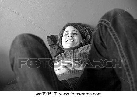 Woman lying on her bed View Large Photo Image Stock Photo - Woman lying on her bed. Fotosearch