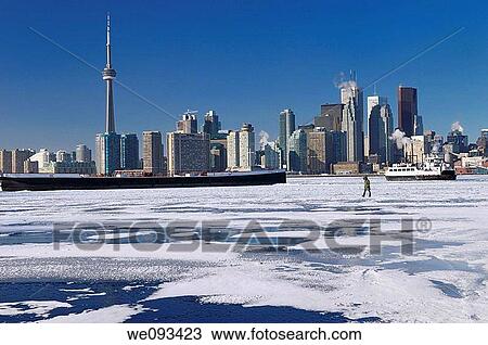 Woman walking on frozen Lake Ontario as the Wards Island Ferry returns to Toronto View Large Photo Image Stock Image - Woman walking on frozen Lake Ontario as the Wards Island Ferry returns to Toronto. Fotosearch