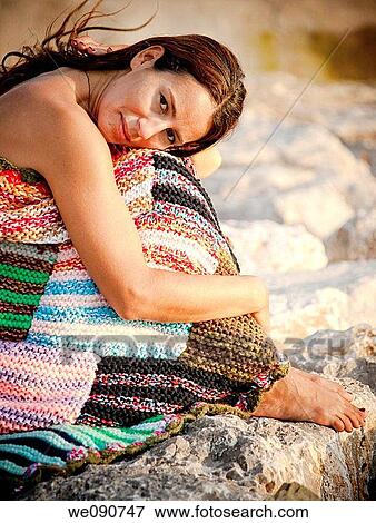 Stock Photo - Woman with blanket in the evening. Fotosearch