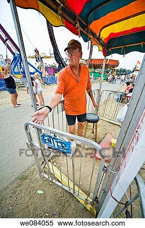 Stock Photography - Worker operating a ride at a carnival. Fotosearch