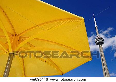 Yellow beach umbrella at urban beach of HTO Park Toronto with CN tower and blue sky View Large Photo Image Stock Photograph - Yellow beach umbrella at urban beach of HTO Park Toronto with CN tower and blue sky. Fotosearch
