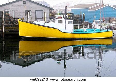 Stock Image - Yellow lobster boat in fog at Fishermans Cove Eastern Passage Halifax Nova Scotia. Fotosearch
