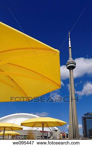 Yellow metal beach umbrellas at urban beach of HTO Park with CN tower and Rogers Centre stadium View Large Photo Image Stock Photo - Yellow metal beach umbrellas at urban beach of HTO Park with CN tower and Rogers Centre stadium. Fotosearch