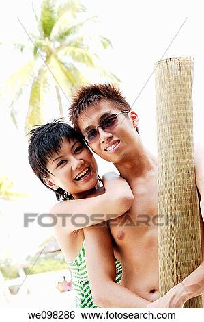 Young asian couple looking at camera View Large Photo Image Stock Photograph - Young asian couple looking at camera. Fotosearch