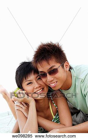 Stock Photography - Young asian couple looking at camera. Fotosearch