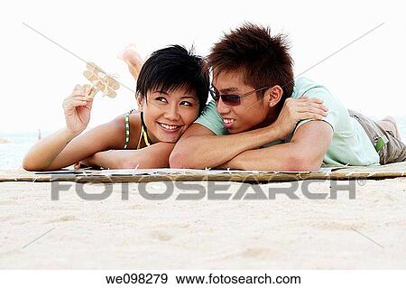 Young asian couple with girl holding a toy airplane View Large Photo Image Stock Photo - Young asian couple with girl holding a toy airplane. Fotosearch