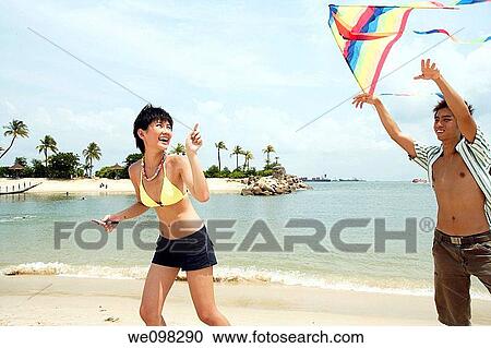 Young asian couple with kite View Large Photo Image Stock Image - Young asian couple with kite. Fotosearch