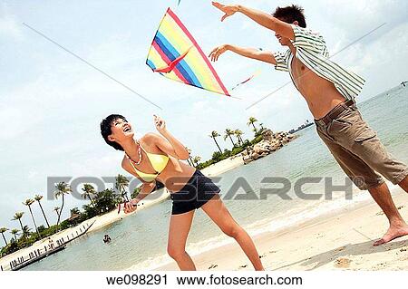 Young asian couple with kite View Large Photo Image Stock Image - Young asian couple with kite. Fotosearch