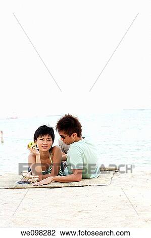 Young asian woman looking at camera and boyfriend View Large Photo Image Stock Image - Young asian woman looking at camera and boyfriend. Fotosearch
