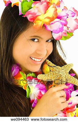 Young Asian woman posing in a swimsuit with flowers and holding a starfish View Large Photo Image Stock Image - Young Asian woman posing in a swimsuit with flowers and holding a starfish. Fotosearch