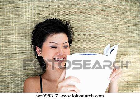 Young asian woman reading book View Large Photo Image Stock Photo - Young asian woman reading book. Fotosearch