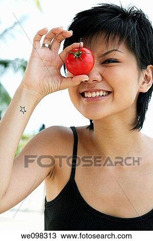 Young asian woman winking and smiling View Large Photo Image Stock Image - Young asian woman winking and smiling. Fotosearch