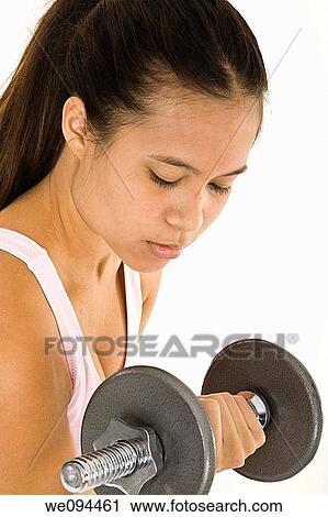 Young Asian woman working out with dumbbells View Large Photo Image Stock Image - Young Asian woman working out with dumbbells. Fotosearch