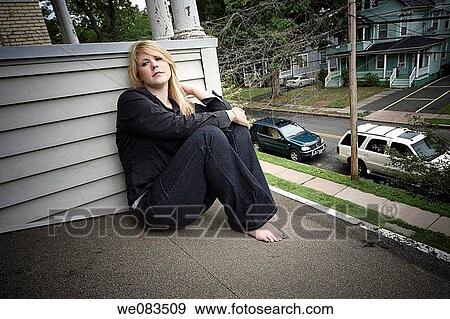 Young blond woman sitting on the roof of her house. View Large Photo Image Stock Photo - Young blond woman sitting on the roof of her house.. Fotosearch