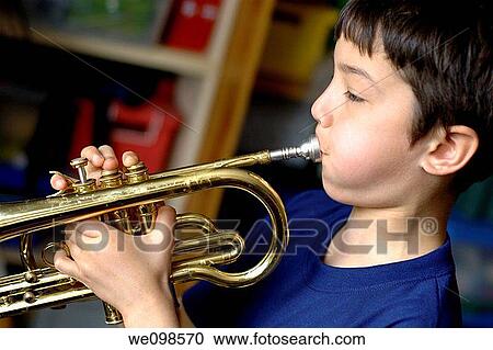 Young boy breathing into a saxophone in his bedroom View Large Photo Image Stock Image - Young boy breathing into a saxophone in his bedroom. Fotosearch