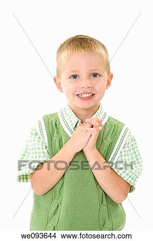 Young caucasian boy dressed in a casual outfit and standing on a white background He is smiling View Large Photo Image Picture - Young caucasian boy dressed in a casual outfit and standing on a white background He is smiling. Fotosearch