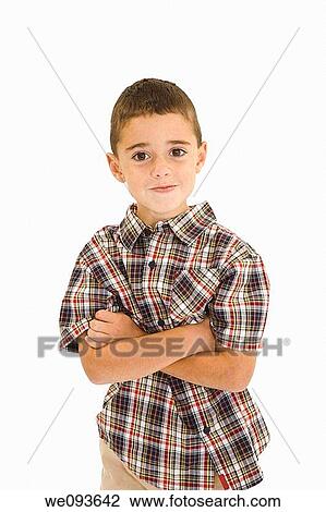 Young caucasian boy dressed in a casual outfit and standing on a white background He is standing with his arms across his chest View Large Photo Image Stock Image - Young caucasian boy dressed in a casual outfit and standing on a white background He is standing with his arms across his chest. Fotosearch