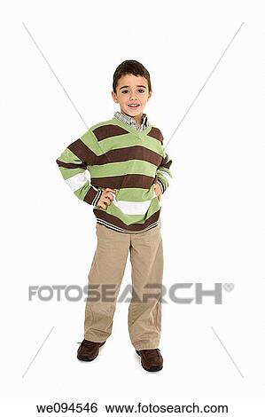 Young caucasian boy dressed in a casual outfit and standing on a white background View Large Photo Image Stock Photograph - Young caucasian boy dressed in a casual outfit and standing on a white background. Fotosearch
