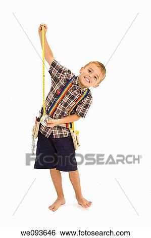 Young caucasian boy dressed in a carpenter outfit standing on a white background View Large Photo Image Stock Photograph - Young caucasian boy dressed in a carpenter outfit standing on a white background. Fotosearch