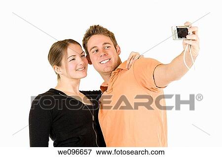Young Caucasian couple taking a photo of themselfs View Large Photo Image Stock Photo - Young Caucasian couple taking a photo of themselfs. Fotosearch