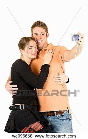 Young Caucasian couple taking a photo of themselfs View Large Photo Image Stock Photo - Young Caucasian couple taking a photo of themselfs. Fotosearch