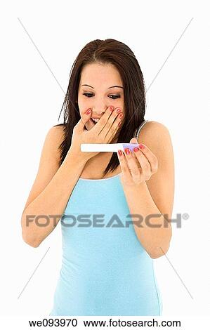 Young Caucasian woman looking at pregnancy test View Large Photo Image Stock Image - Young Caucasian woman looking at pregnancy test. Fotosearch