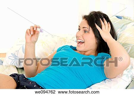 Young Caucasian woman looking at pregnancy test View Large Photo Image Stock Image - Young Caucasian woman looking at pregnancy test. Fotosearch