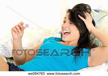Young Caucasian woman looking at pregnancy test View Large Photo Image Stock Image - Young Caucasian woman looking at pregnancy test. Fotosearch