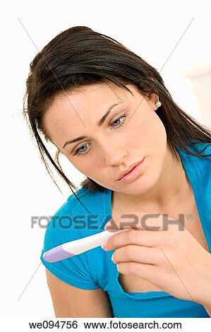 Young Caucasian woman looking at pregnancy test View Large Photo Image Stock Photograph - Young Caucasian woman looking at pregnancy test. Fotosearch