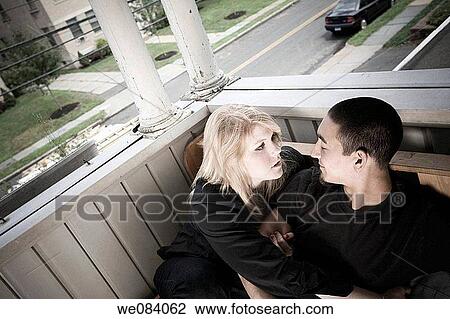 Young couple sitting on their porch View Large Photo Image Stock Image - Young couple sitting on their porch. Fotosearch