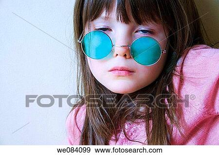 Young girl wearing green colored sunglasses. View Large Photo Image Stock Photo - Young girl wearing green colored sunglasses.. Fotosearch