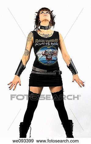 Young heavy metal female punk fan standing tall with horns piercings and tattoos on a white background View Large Photo Image Stock Photo - Young heavy metal female punk fan standing tall with horns piercings and tattoos on a white background. Fotosearch