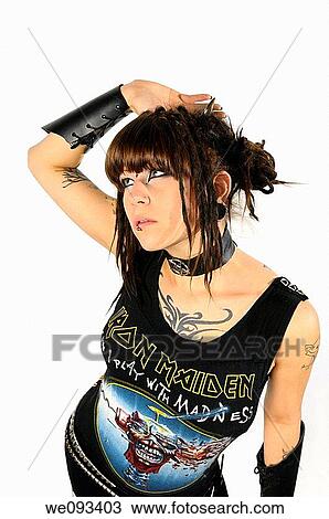 Stock Image - Young heavy metal lady with horns piercings and tattoos on a white background. Fotosearch