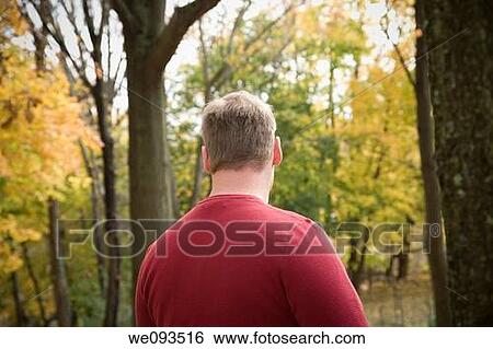 Stock Photograph - Young man in his backyard. Fotosearch
