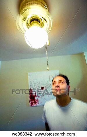 Young man posing in his apartment. View Large Photo Image Stock Image - Young man posing in his apartment.. Fotosearch
