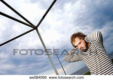 Young man, with a mustache and beard, standing beside a metal frame. View Large Photo Image Stock Photography - Young man, with a mustache and beard, standing beside a metal frame.. Fotosearch