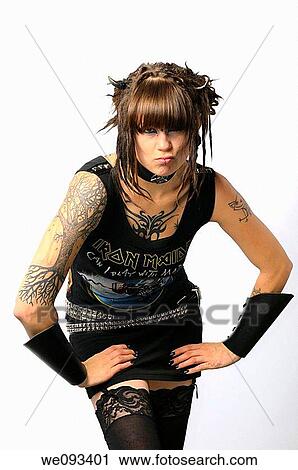 Young pouting heavy metal lady with horns piercings and tattoos on a white background View Large Photo Image Stock Image - Young pouting heavy metal lady with horns piercings and tattoos on a white background. Fotosearch