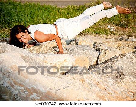 Stock Image - Young woman doing exercise. Fotosearch