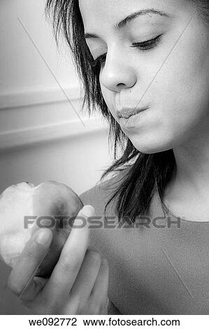 Young woman eating an apple View Large Photo Image Stock Image - Young woman eating an apple. Fotosearch