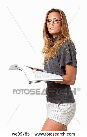 young woman in her 20s reads a fashion magazine on white background Model release available View Large Photo Image Stock Image - young woman in her 20s reads a fashion magazine on white background Model release available. Fotosearch