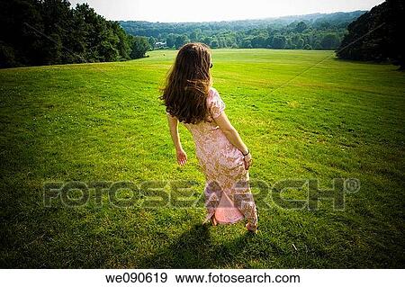 Young woman posing at a park View Large Photo Image Stock Photo - Young woman posing at a park. Fotosearch