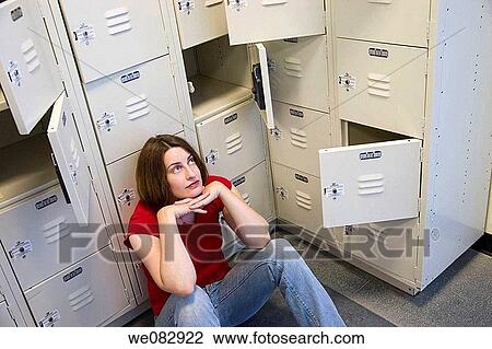 Young woman sitting among a group of lockers. View Large Photo Image Stock Image - Young woman sitting among a group of lockers.. Fotosearch