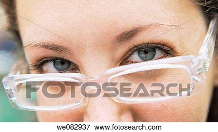 Young woman wearing glasses, close-up View Large Photo Image Stock Photo - Young woman wearing glasses, close-up. Fotosearch