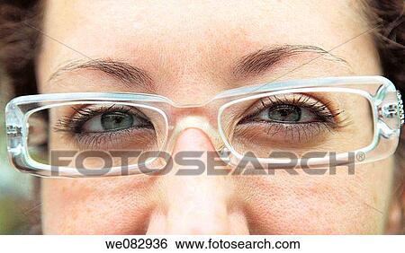 Young woman wearing glasses, portrait View Large Photo Image Stock Photograph - Young woman wearing glasses, portrait. Fotosearch