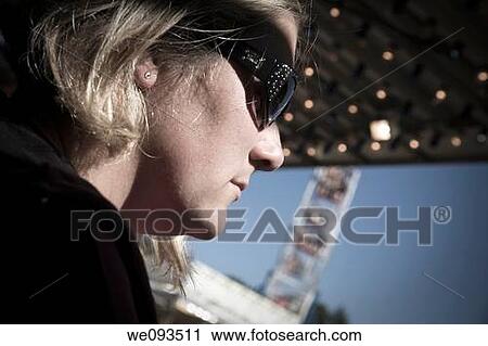 Young woman wearing sunglasses View Large Photo Image Stock Image - Young woman wearing sunglasses. Fotosearch