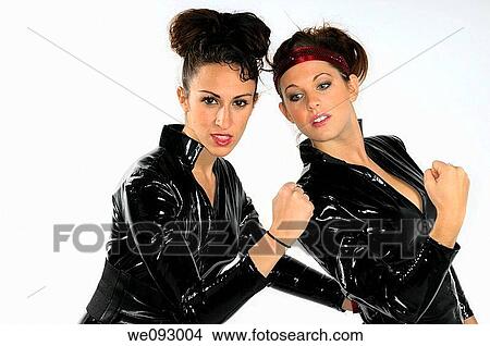 Young women making a fist in black plastic catsuits on white background View Large Photo Image Picture - Young women making a fist in black plastic catsuits on white background. Fotosearch