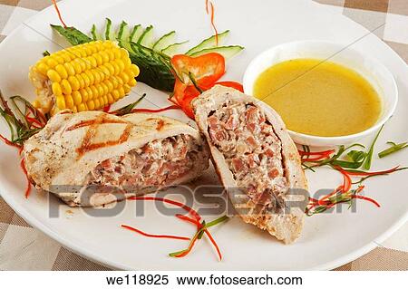 A delicious Stuffed Chicken Kiev served with corn View Large Photo Image Stock Photography - A delicious Stuffed Chicken Kiev served with corn. Fotosearch